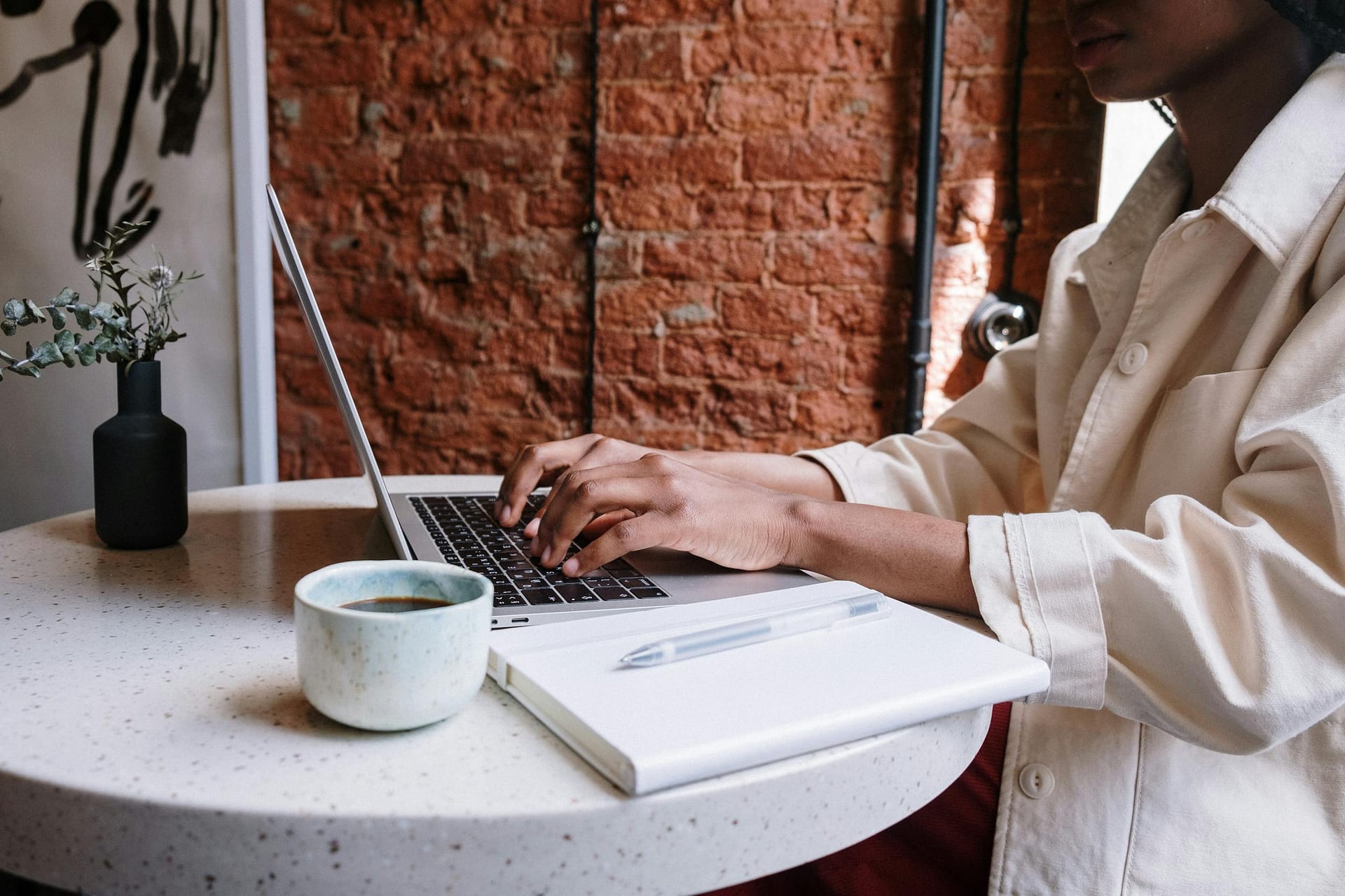 Minimal workspace showing laptop and coffee representing blog promotion and content creation